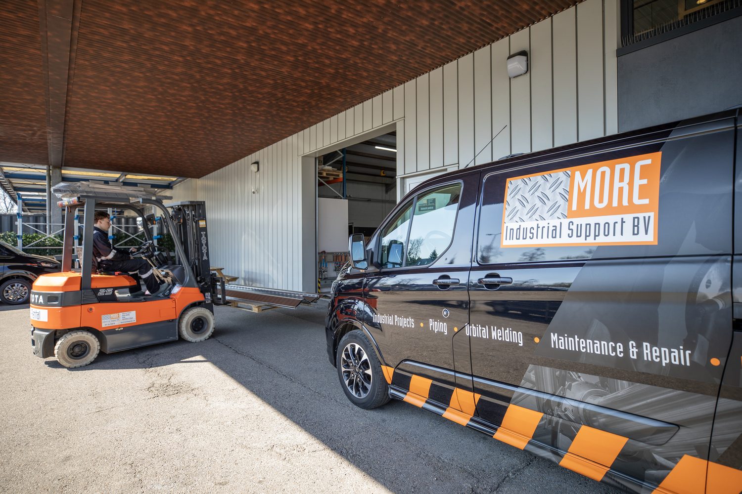 Bedrijfspand met bedrijfswagens en heftruck van More Industrial Support